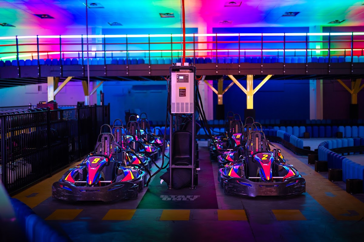 Electric hire karts lined up on the grid at an indoor karting centre